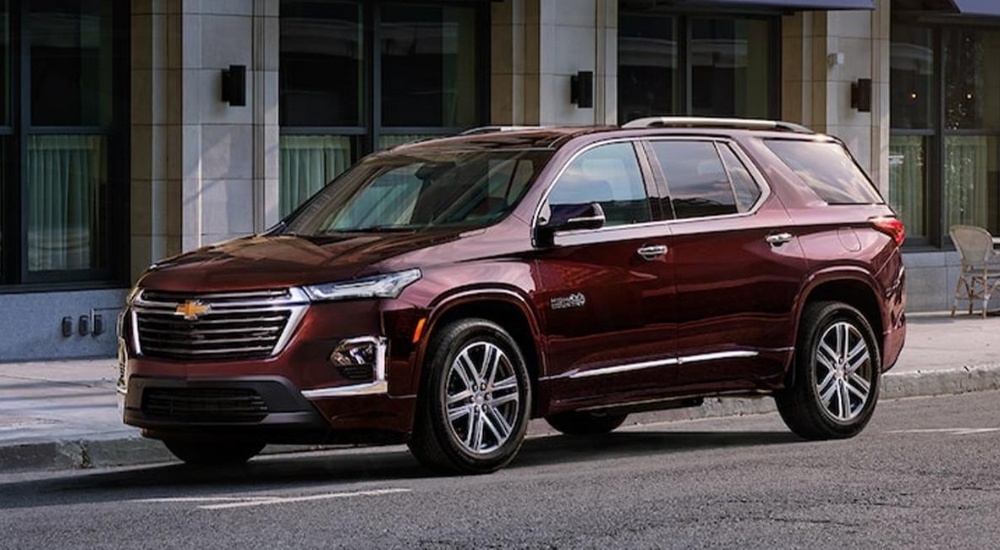 A maroon 2022 Chevy Traverse High Country is parked on the side of a street.