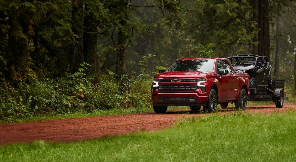 A red 2025 Chevy Silverado 1500 for sale is shown an ATV.