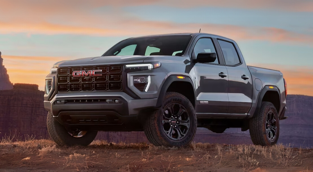 A gray 2025 GMC Canyon Elevation parked off-road at sunset