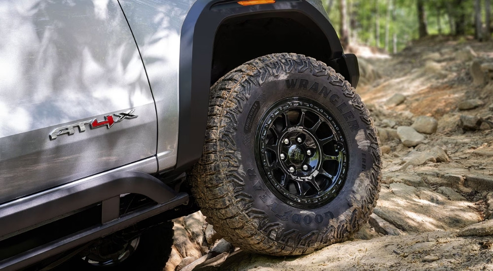 Tire and rim on a 2025 GMC Canyon AT4X off-roading on a rocky trail