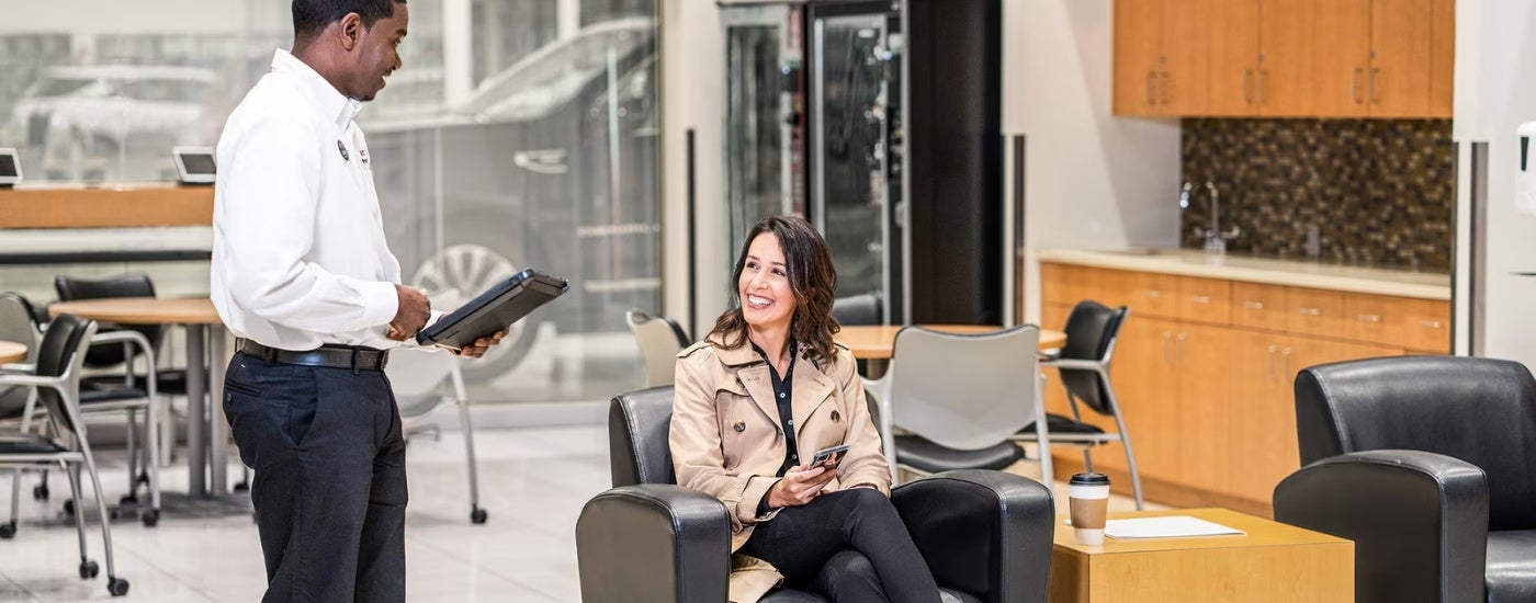 Smiling people are shown in the waiting room in a Chevrolet GMC dealer near Nashville, TN.