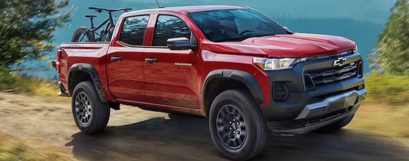 A red 2024 Chevy Colorado Trail Boss driving off-road.