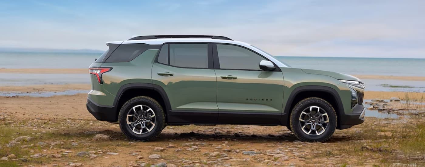 A green 2025 Chevy Equinox parked near water.