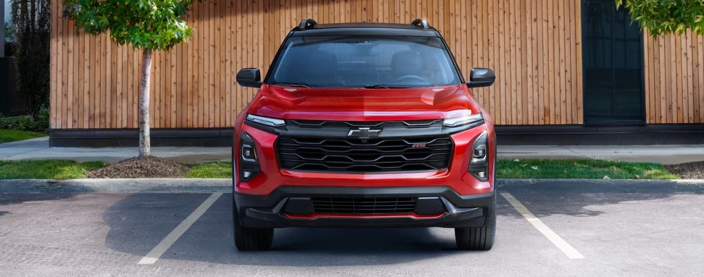 A red 2025 Chevy Equinox RS parked on a parking spot.