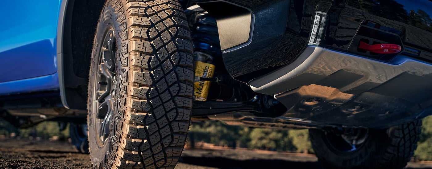 Close-up on the wheels of a blue 2025 Chevy Silverado 1500.