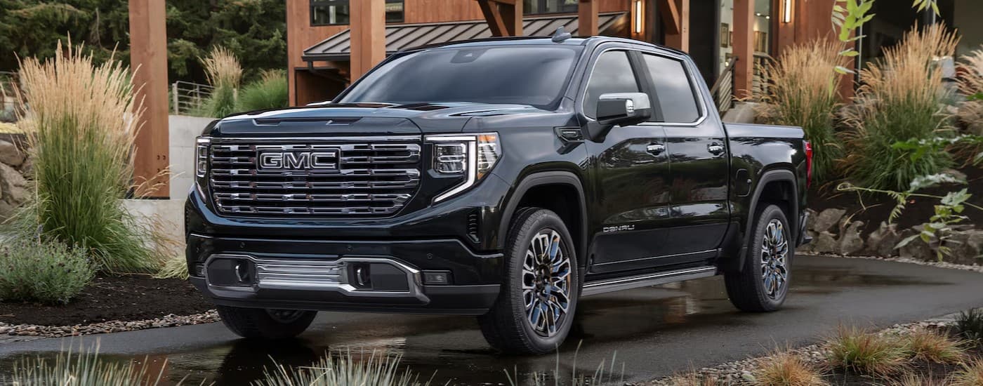 A black 2026 GMC Sierra 1500 parked on a driveway.