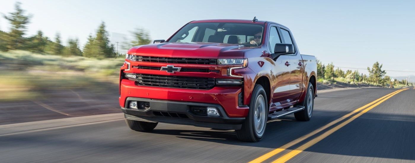 Red 2020 Chevy Silverado 1500 Z71 driving down a road.